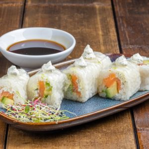 Spring maki garni de saumon frais et d'avocat crémeux, enveloppé dans une fine tranche de concombre.